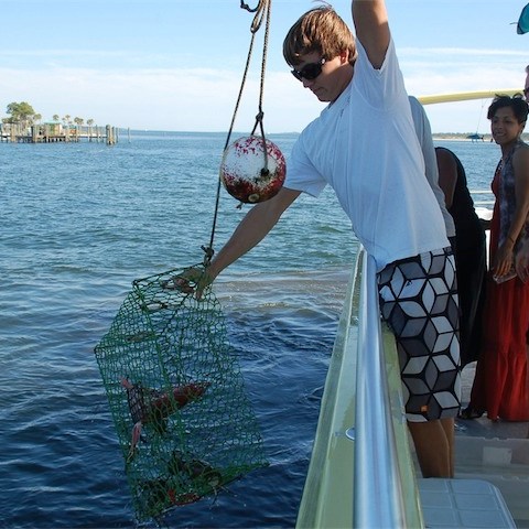 a man standing next to a body of water